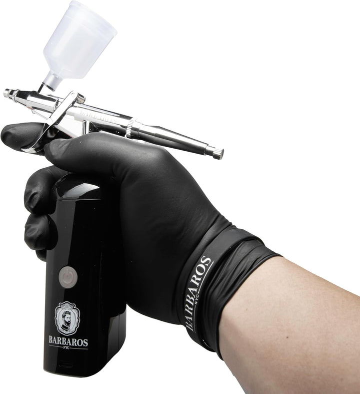 Barbaros Airbrush held in hand with black vinyl glove